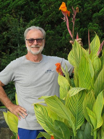 Tom Dakin’s cannas are taller than he is.