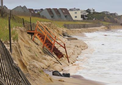 Repairs will be made by the Army Corps after ocean waves last weekend washed away sand, exposing the sandbag seawall installed by the federal agency along the downtown Montauk beach, and leaving a stairway over the dune precariously perched above the surf.