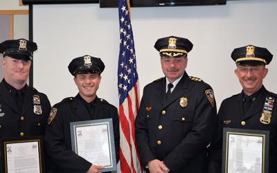 Chief Gerard Larsen, second from right, congratulated officers who helped save the life of a man who collapsed at the Maidstone Club in September, from left, Officer Matt Kochanasz, Officer Steven Niggles, and Sgt. Richard Mamay.