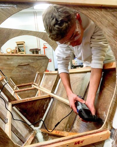 Henry Saar, a student in one of Andy Rigby’s woodworking classes at East Hampton High School, worked on the catamaran students are building under the guidance of the Montauk Catamaran Company.