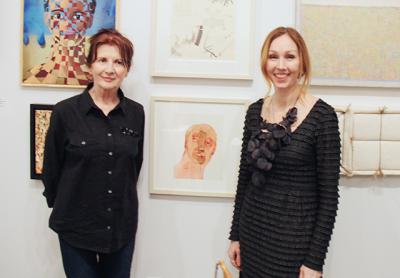 Joyce Kubat, left, winner of top honors, and Andrea Grover, Guild Hall’s executive director, flanked “Armour,” Ms. Kubat’s winning entry.