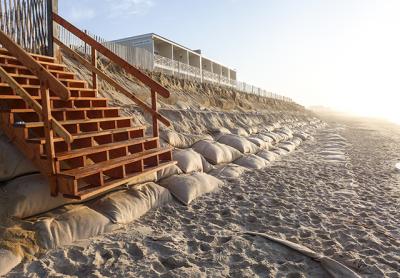 The sandbag wall on Montauk’s downtown beach will be repaired and covered with sand by contractors for the Army Corps of Engineers one more time.