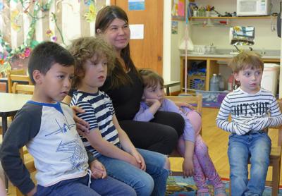 The Country School in Wainscott, founded by Deena Zenger, seen here sitting with students, received an eviction notice from East Hampton Town this week.