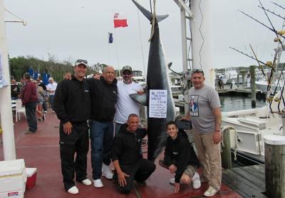 The crew of the Gotta’ Go posed with their 453-pound mako, the winning fish in the Star Island Yacht Club’s shark tournament last weekend.