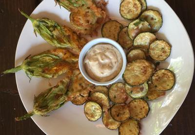 It’s not too early for locally grown zucchini blossoms, at least from the greenhouse. Peanut oil can take the heat required for high-temperature frying without burning.