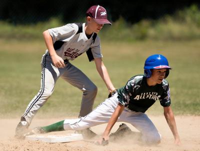 Eli Wolf, the Grey team’s shortstop, put the tag on an East End base runner in the second inning of an 11-to-12-year-old Little League playoff game at the Pantigo Fields.