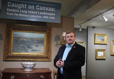 Terry Wallace greeted visitors at the opening reception on Friday for “Caught on Canvas: Views of Eastern Long Island Landscapes From the Wallace Collection, 1850-1935,” a show of a portion of his holdings through July 23 at the Clinton Academy.