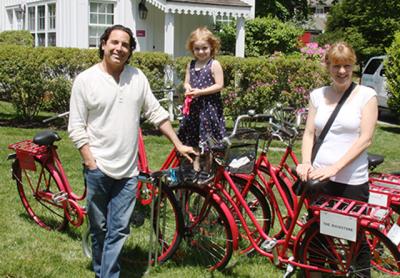 Jonathan Baker and Jenny Ljungberg got ready for a bicycle ride with Maddie, their daughter, outside the Maidstone Hotel in East Hampton, which they own.