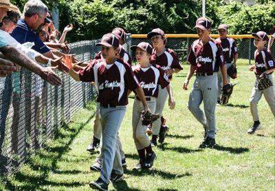 Atta boy: East Hampton’s 9-10 Little Leaguers were congratulated by their parents after Sunday’s 13-4 win here over Patchogue-Medford. On Monday, in Riverhead, they won the District 36 championship.