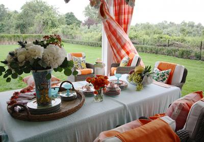 The covered porch at the house at 78 Rosko Lane in Southampton, also referred to as Linden, was designed by Lisa Mende with a pop of orange.