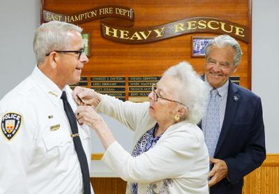 Elaine Defalco, a daughter of Fritz Leddy, a former chief of the East Hampton Village Police Department, pinned Mr. Leddy’s shield to her son-in-law, Michael Tracey.