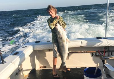 Bennett Burki, 14, caught a 35-pound striped bass on the charter boat Hurry Up off Montauk on Monday. 	Peter Burki