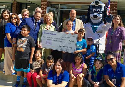 Representatives from United Healthcare presented the Springs School with a check for $3,500 to officially launch the Springs chapter of Blessings in a Backpack, which helps feed schoolchildren on weekends.