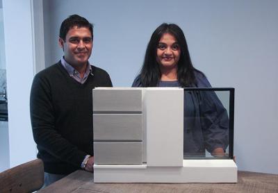 Punit Chugh and Anjali Gupta display a model of a premade wall. Below, this modernist Davinci Haus was custom designed.