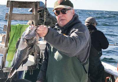 Tim Mott of Sag Harbor held a sea bass taken on Friday aboard the Oh Brother out of Montauk.