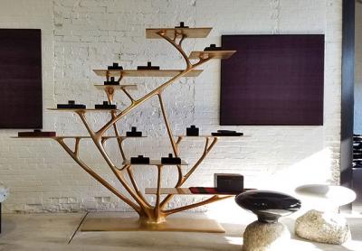 Conrad de Kwiatkowski’s small basalt objects are placed on a Joris Laarman bronze etagere, with the Aymara weavings he has collected over the years hanging behind them.