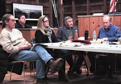 While new East Hampton Town Trustees, including, at right, John Aldred and Susan Vorpahl, sat down for their first meeting, the board’s attorney, Richard Whalen, in the background, announced he would step down.