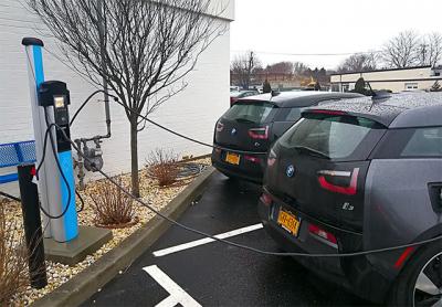 A sign of things to come: Electric cars fueled up at parking meter-style electric pumps at the Southampton BMW dealership.