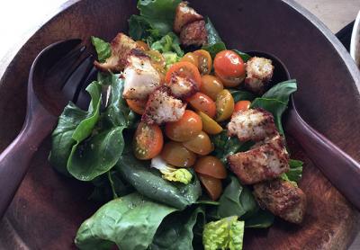 A salad of spinach, romaine, cherry tomatoes, and homemade croutons is a great transitional dish from winter to spring.