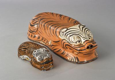 Objects from the Leibers’ collection of Chinese ceramics include a tiger-form pillow with tiger handbag.