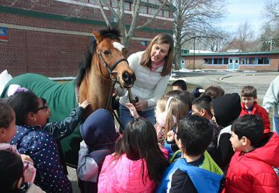 Joanne Jiminez of Hamptons Pony Parties and Jiminez Jumpers brought Annie the pony to meet first graders at the John M. Marshall Elementary School during a lunchtime Brown Bag enrichment event on Friday.