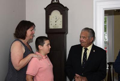 Standing in front of the Dominy clock that they donated to East Hampton Village, Maureen McFall Cayer and her son, David, met with Mayor Paul F. Rickenbach Jr. in the office of Robert Hefner, the village’s director of historic  services, last Thursday.