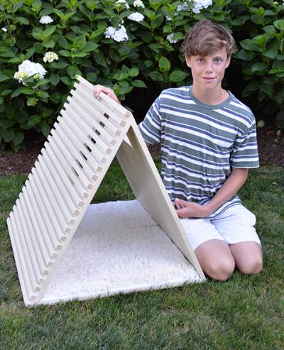 Luke Louchheim, 14, next to his Alpha Dog house, designed and built for his arfITECTURE project, 10 houses available for auction to benefit the Animal Rescue Fund of the Hamptons.