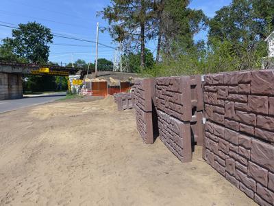 Construction of the retaining walls under the village’s railroad trestles will include the installation of concrete blocks.