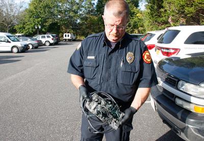 Dwayne Denton, an East Hampton Town fire marshal, held a melted power strip that caught fire in a Springs School classroom on Monday. “This is what can happen when power strips are overloaded,” he said.