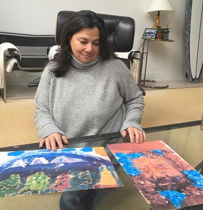 Laura Auerbach, one of 25 volunteers who answered an emergency plea to house the displaced children of a local woman facing deportation, showed some of the paintings her Latino trauma patients have produced in art therapy.