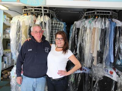 Eddie Downes, left, a presser at East Hampton Cleaners for 30 years, and Grace LaBarbera, who has worked there for six years, are the only two employees remaining as the shop prepares to close at the end of the month.