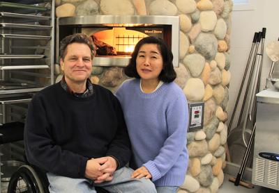 Bruce Damark and Michiko Damark in front of the wood-fired oven in their new and improved 11,000-square-foot Damark’s Deli on Three Mile Harbor Road in East Hampton.