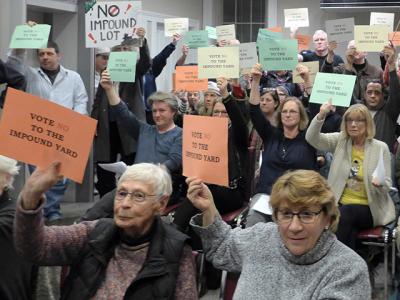 Holding signs and yelling “Shame!” and “No!” a chorus of opponents registered their objections on Tuesday to the Sag Harbor Village Board’s plan for a vehicle impound yard adjacent to the Long Pond Greenbelt.