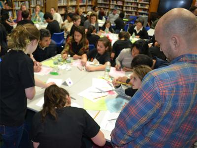 A parent looked on as Springs School sixth graders and families created cultural handprints at the 2018 Diversity Institute.