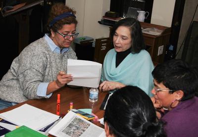 Beatriz Rivas, left, reviewed a writing sample with the teacher, Celia Josephson, during a high school equivalence exam prep class at the East Hampton Library earlier this month.