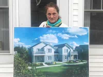 Catherine Casey, the executive director of the East Hampton Housing Authority, displayed a photo of the modular buildings to be constructed for affordable housing in Amagansett.