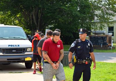 Gilberto Quintana-Crespo, in front, was among the many defendants led into East Hampton Town Justice Court last Thursday to be arraigned on charges related to the takedown of what investigators said was the “largest narcotics distribution ring in and around Montauk.”