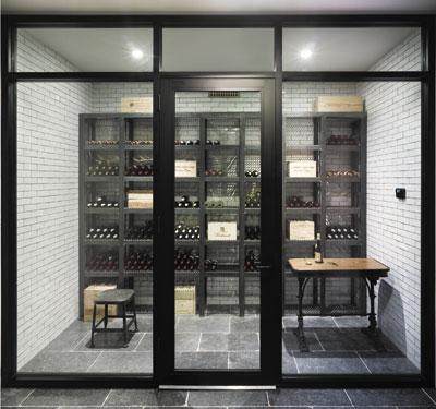 In a house he designed and built on Further Lane in East Hampton Village, Dan Scotti created a wine cellar in the basement with a glass storefront, all the better to admire the wine collection.