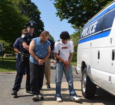 Juan P. Porras and Jose Jaime Restrepo-Perez of Springs were led to their arraignments in East Hampton Town Justice Court Thursday morning.