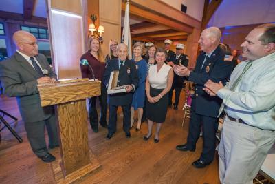 The East Hampton Fire Department honored Joseph DeCristofaro, center, for 60 years as a volunteer firefighter at its annual inspection dinner at the Maidstone Club in East Hampton last month.