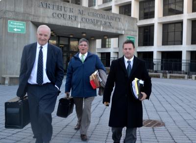 Steven Lee, right, left the courthouse after the first day of his trail on a felony charge of illegal surveillance. With him were his attorneys, Patrick O'Connell, left, and James O'Shea.