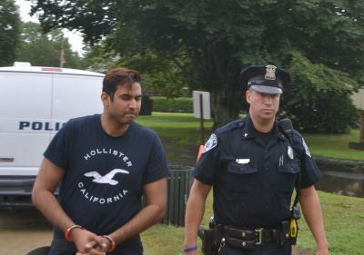 Krishna L. Parihar, who is accused of impersonating a New York City police officer, was led into East Hampton Town Justice Court back in September.