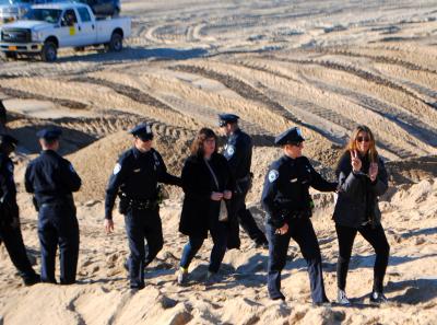 Lisa Spellman, who flashed a peace sign, and Bess Rattray, were arrested on disorderly conduct charges Monday morning.