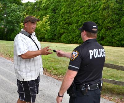 An East Hampton Village police officer handed Matt Agudo his lens cap after an alleged scuffle with Alec Baldwin.