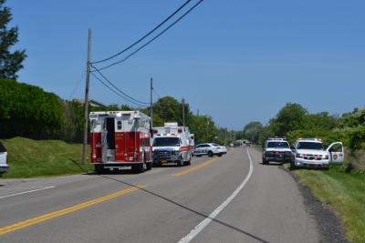 Emergency vehicles at West Lake Drive and South Ferncroft Place after a landscaper was pinned under a riding mower there.