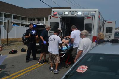 Emergency medical technicians with the Montauk Fire Department loaded a woman into an ambulance after she was thrown from her moped in Montauk on Monday afternoon.