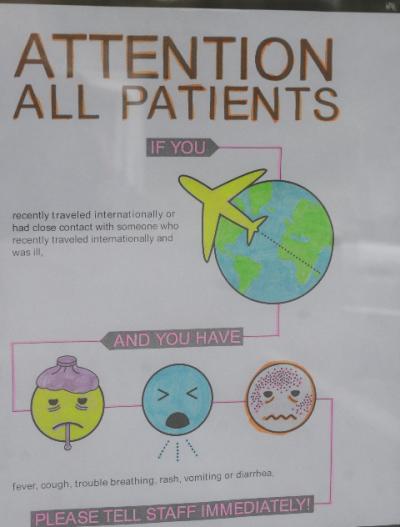 A sign on the door of East Hampton Urgent Care alerted patients to report certain symptoms immediately.