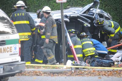 East Hampton Fire Department's heavy rescue squad worked to remove a woman from inside a Subaru that was lying on its side after an accident involving a Dodge 4-door pick-up truck on Wednesday on Newtown Lane, near Cooper Lane, in East Hampton Village.