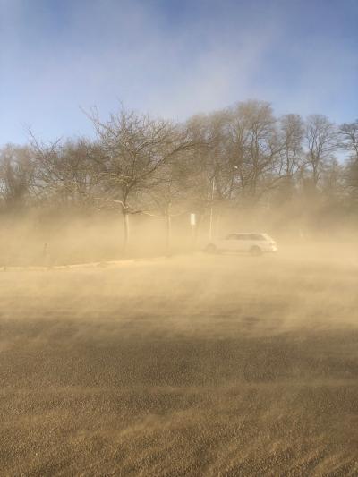 Dust blew off the barren farm field north of Amagansett's Main Street last week, creating a mess on parked cars and sidewalks and for village storekeepers.