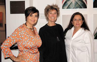 Terry Thompson, Edwina von Gal, and Anahi DeCanio posed in front of Michele Dragonetti’s boat prow collection at Ashawagh Hall in Springs Saturday night.